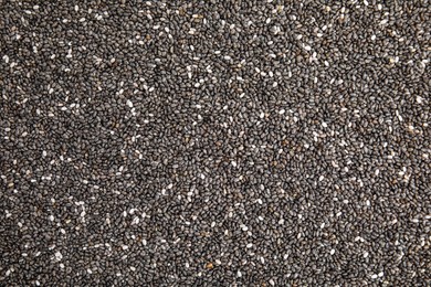 Photo of Heap of chia seeds as background, top view. Veggie food