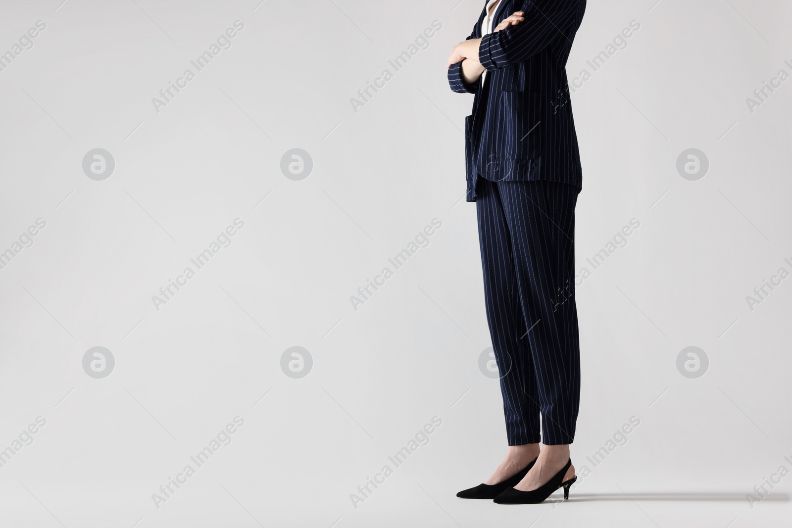 Photo of Businesswoman with crossed arms on white background, closeup