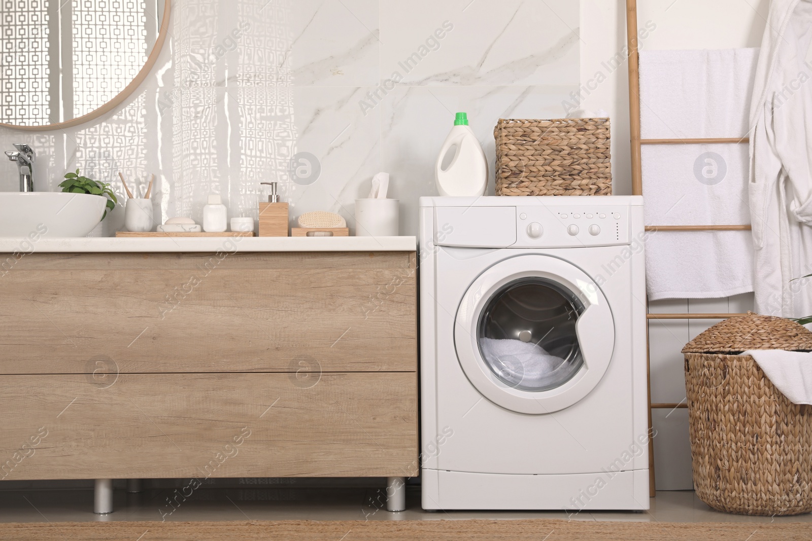 Photo of Stylish bathroom interior with modern washing machine