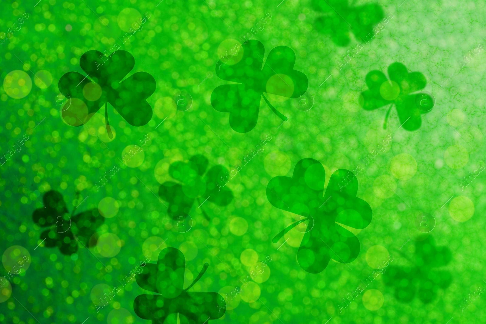 Image of St. Patrick's Day celebration. Clover leaves on green background, bokeh effect