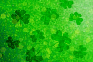 St. Patrick's Day celebration. Clover leaves on green background, bokeh effect