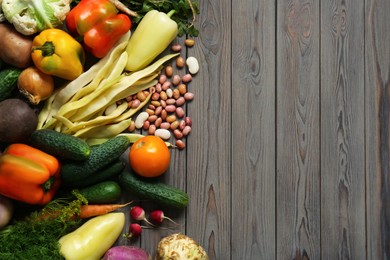 Photo of Different fresh vegetables on wooden table, flat lay with space for text. Farmer harvesting