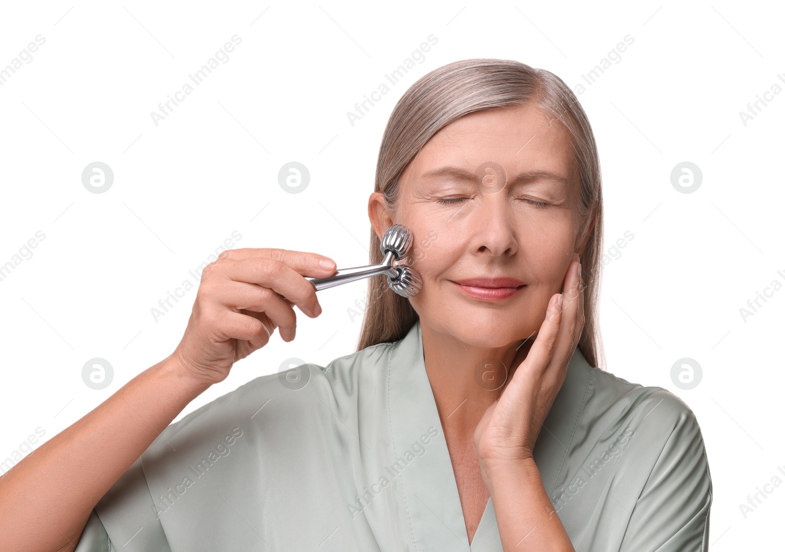 Photo of Woman massaging her face with metal roller isolated on white