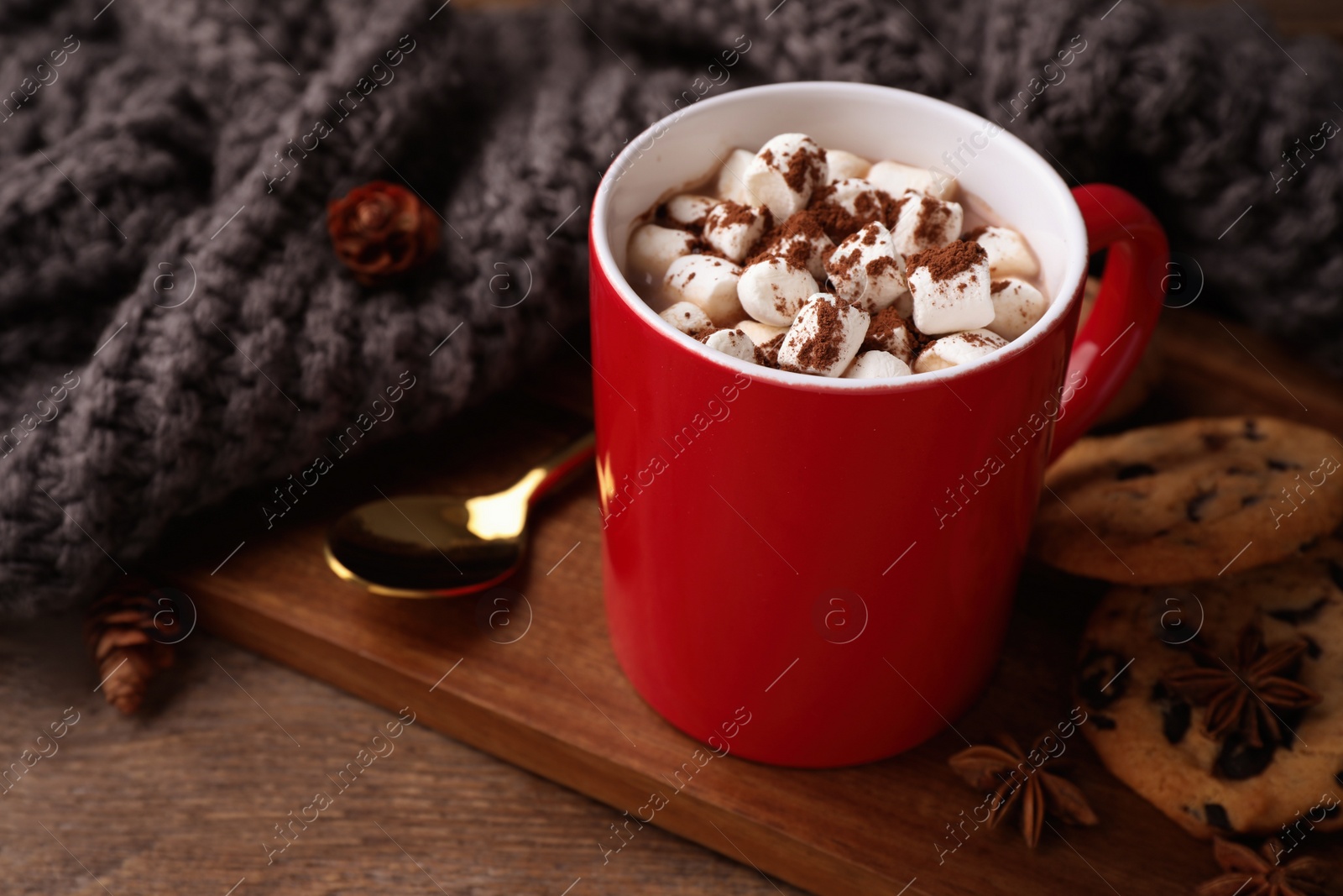 Photo of Composition of tasty cocoa with marshmallows in cup on wooden table. Space for text