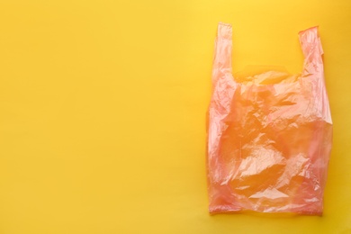 Photo of Clear disposable plastic bag on color background. Space for text