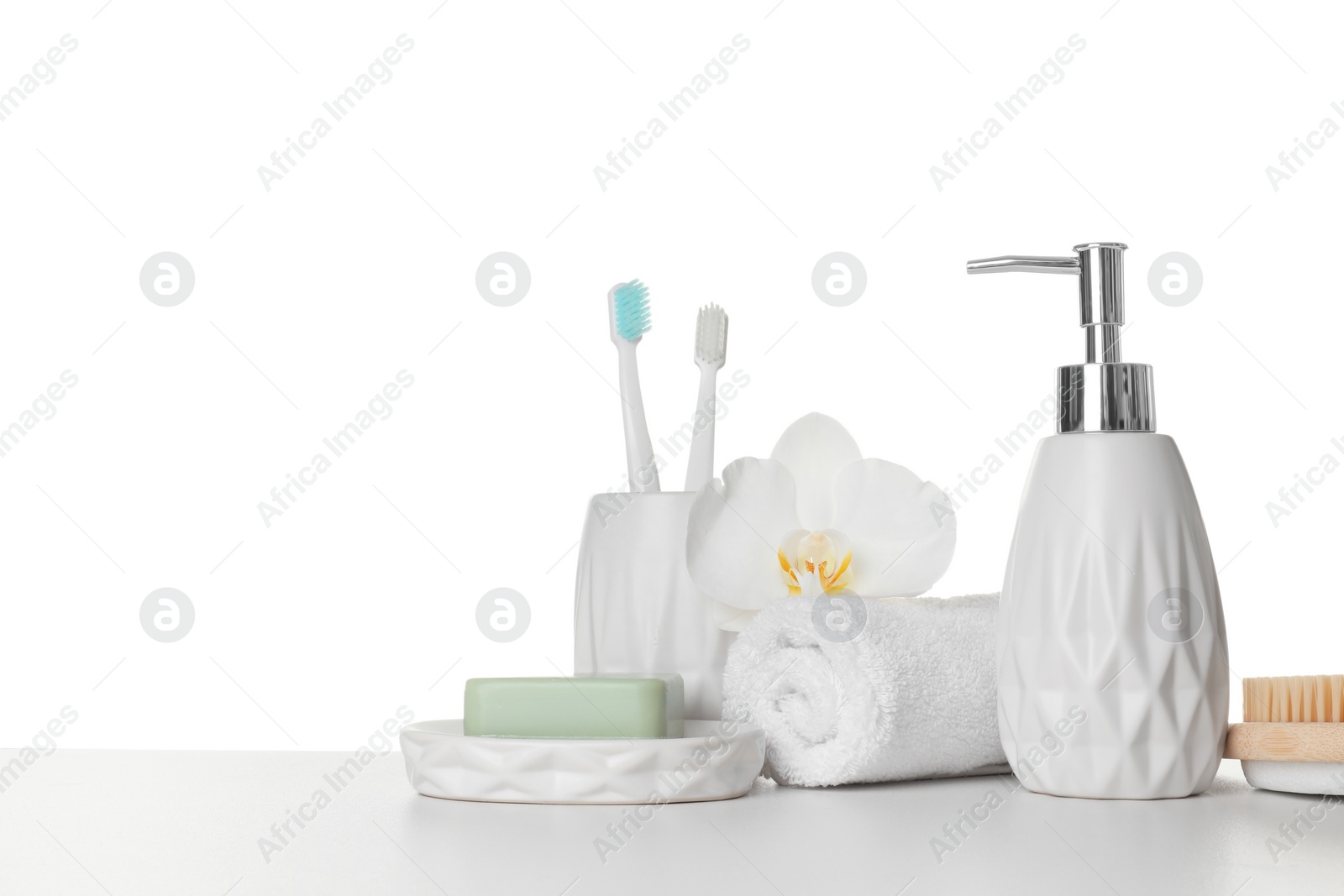 Photo of Bath accessories. Different personal care products and flower on table against white background. Space for text