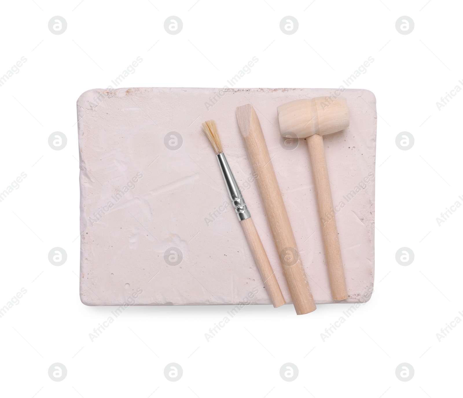 Photo of Educational toy for motor skills development. Excavation kit (plaster, digging tools and brush) isolated on white, top view