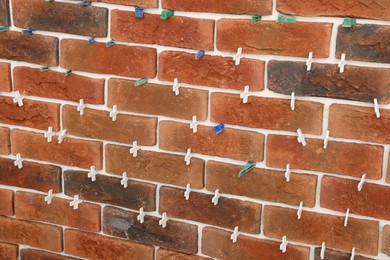 Photo of Decorative bricks with tile leveling system on wall