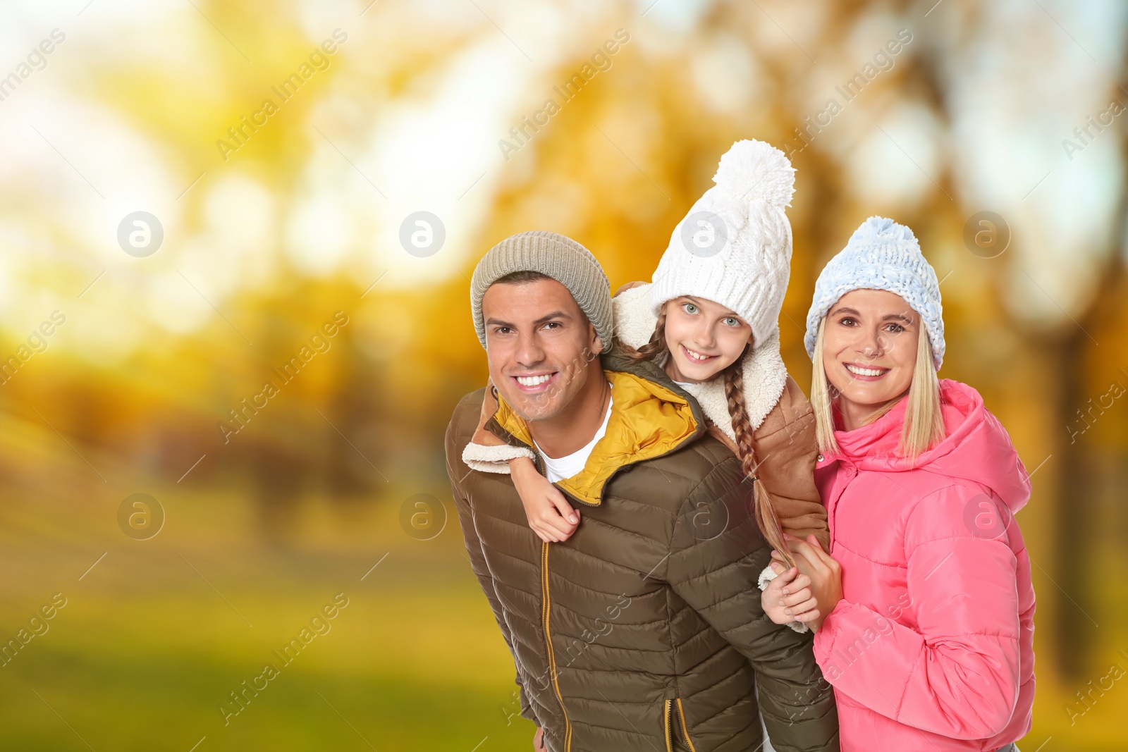 Image of Happy family spending time together at autumn park 