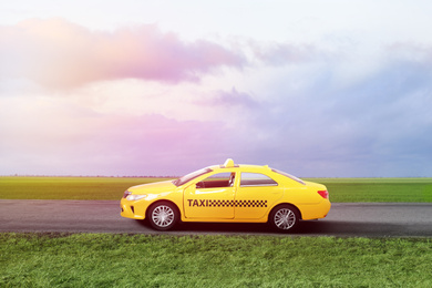 Yellow taxi car on asphalt highway outdoors 
