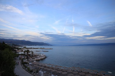 Photo of Many beach umbrellas near sea at resort