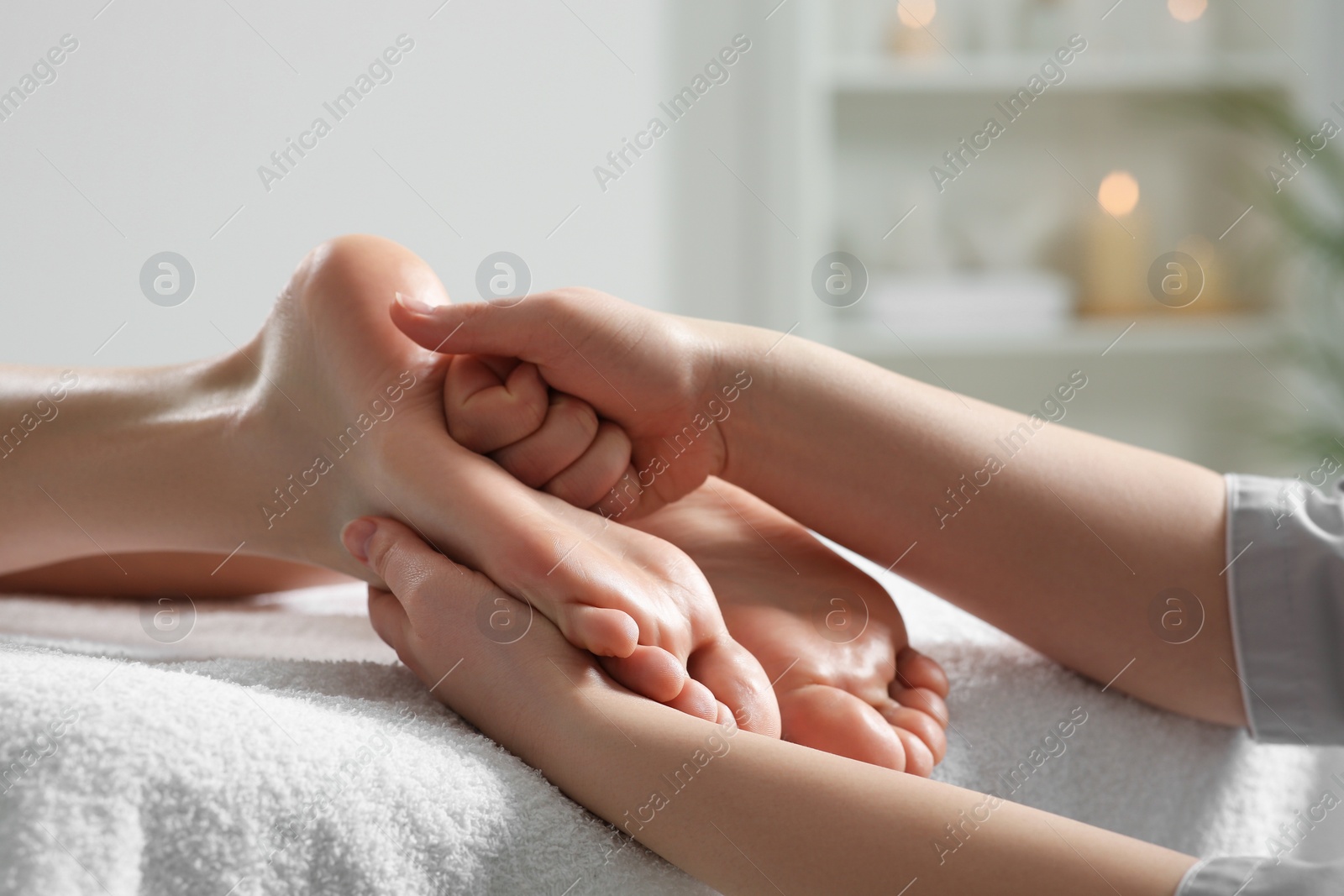 Photo of Woman receiving foot massage in spa salon, closeup