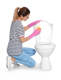 Woman cleaning toilet bowl in bathroom