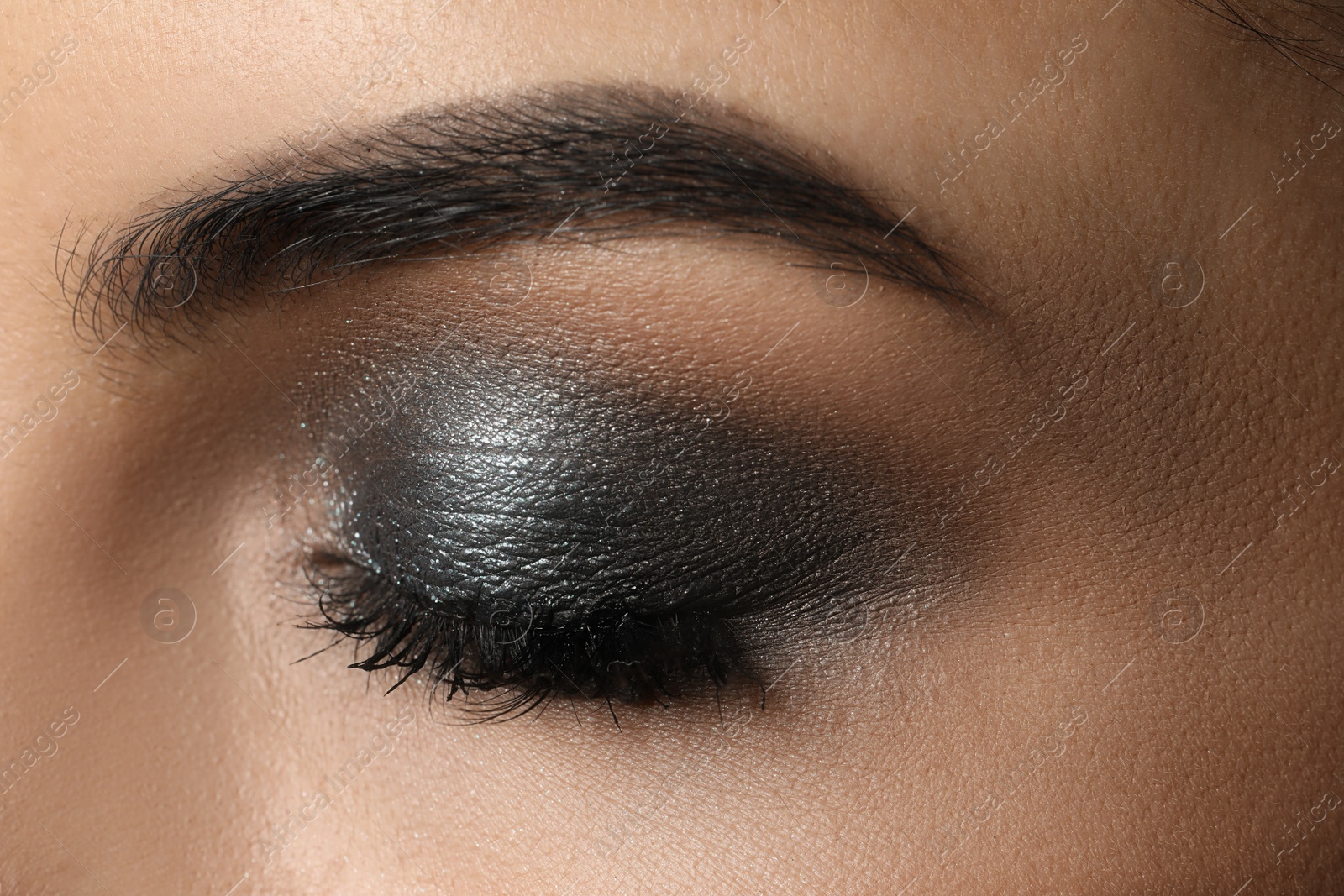 Photo of Young woman with evening makeup, closeup. Eye shadow product