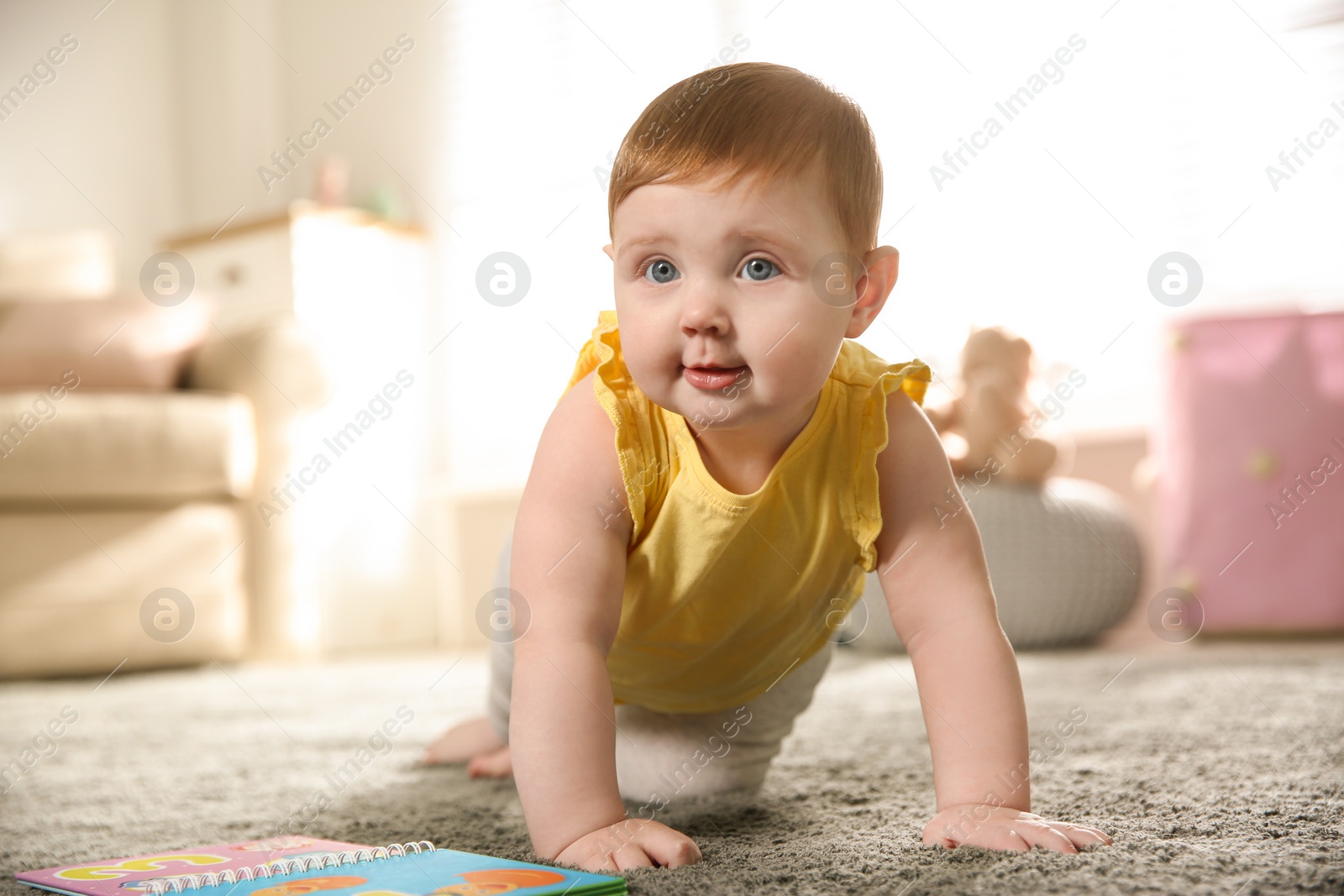 Photo of Cute little baby girl crawling at home