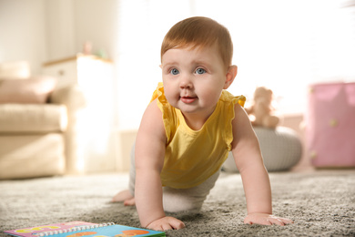 Cute little baby girl crawling at home