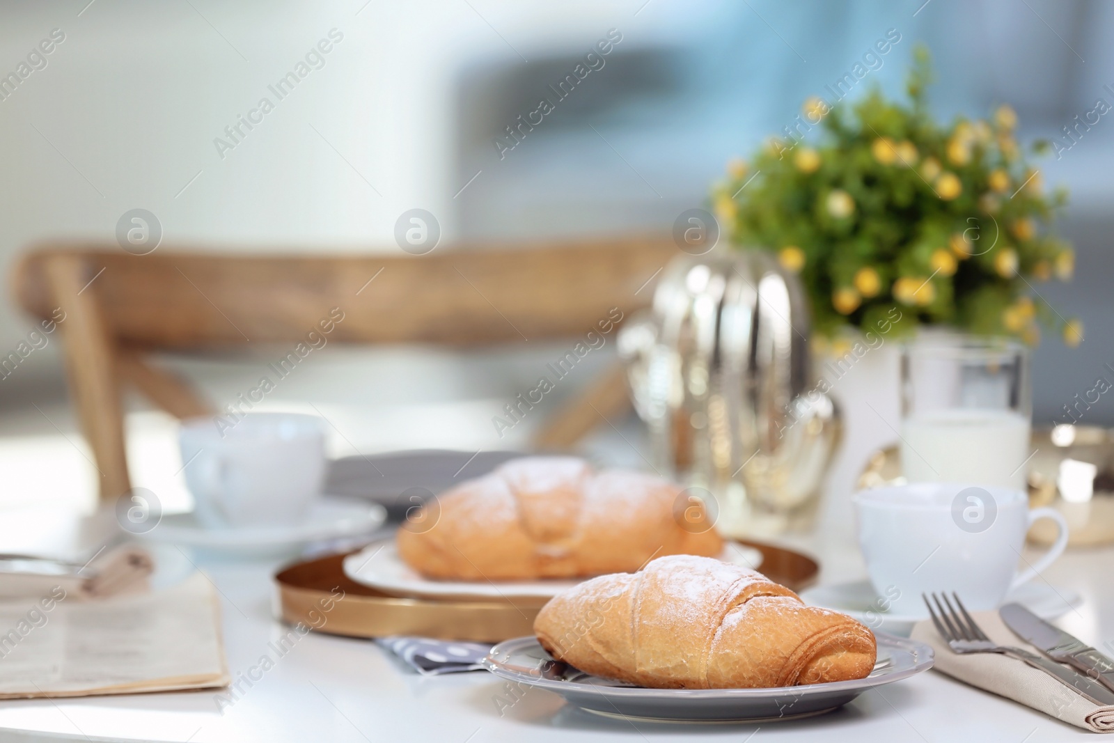 Photo of Tasty breakfast with fresh croissants on table