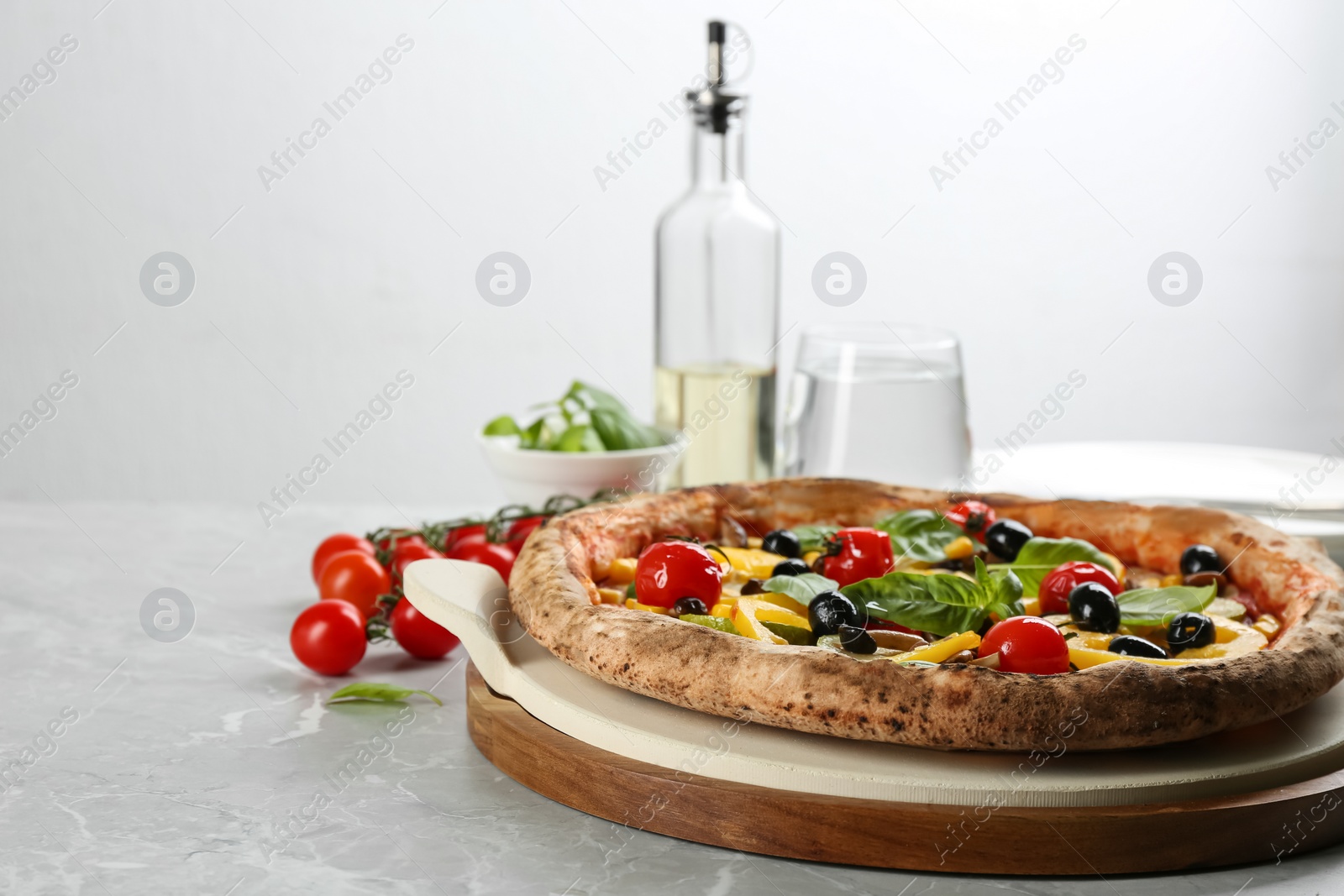 Photo of Tasty vegetable pizza on light grey table