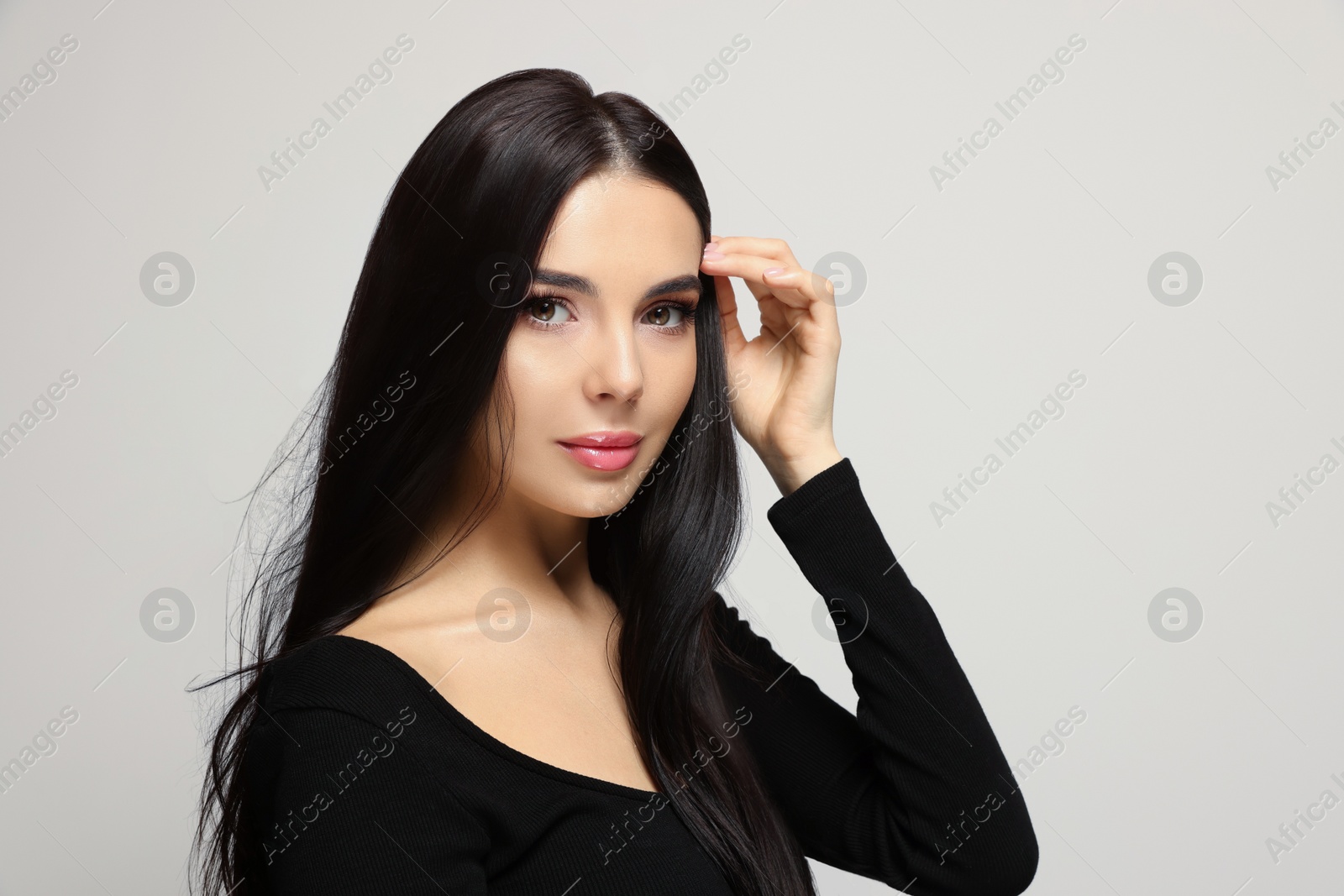 Photo of Portrait of beautiful young woman on light grey background