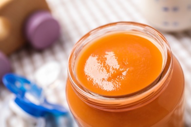 Photo of Healthy baby food in jar on table, closeup