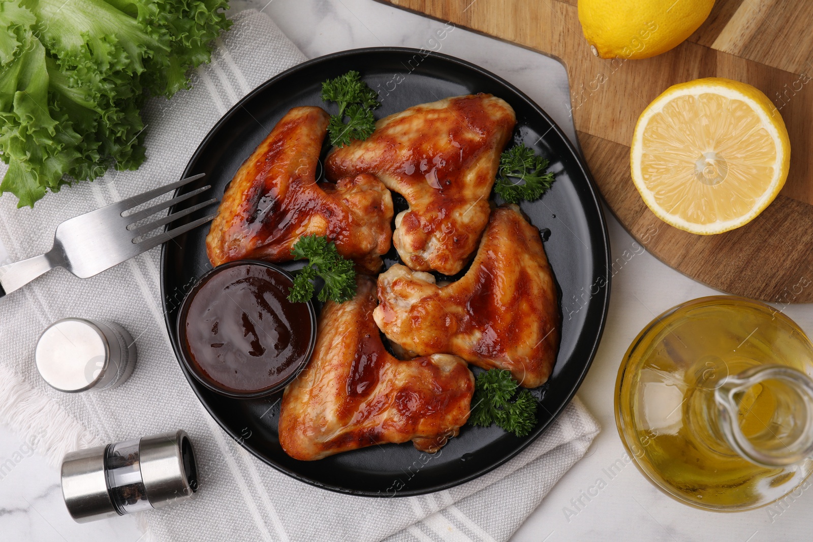 Photo of Flat lay composition with marinade and chicken wings on white table