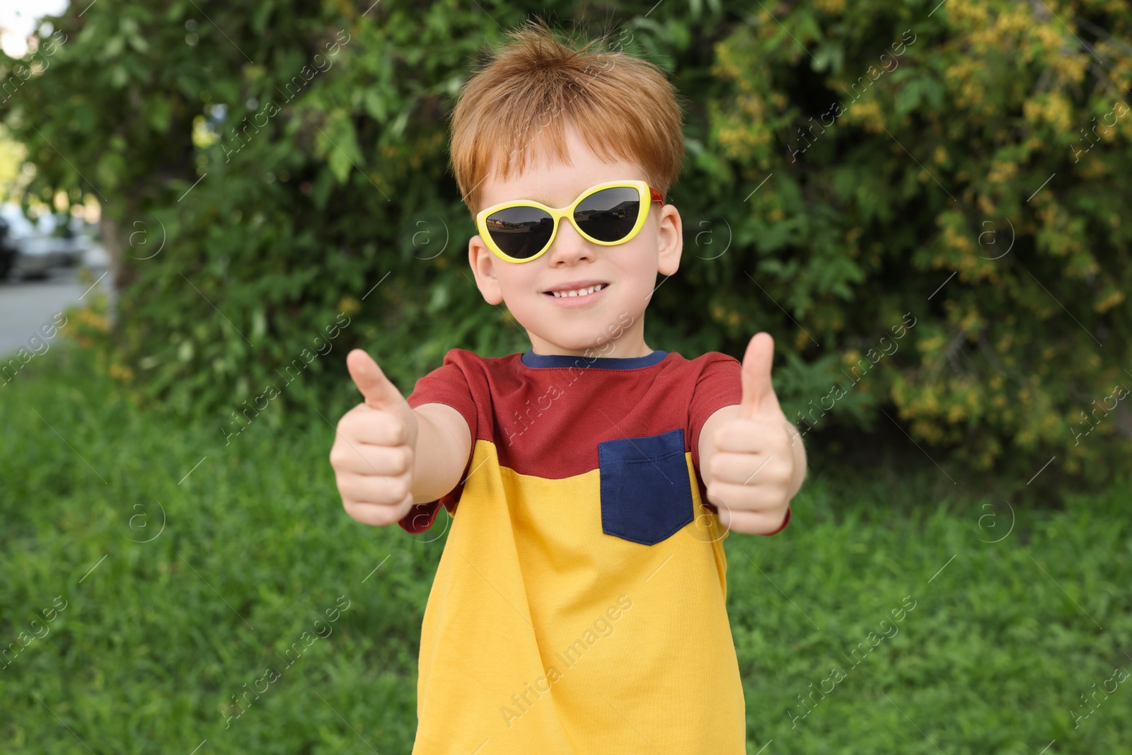 Photo of Cute little boy with sunglasses in park