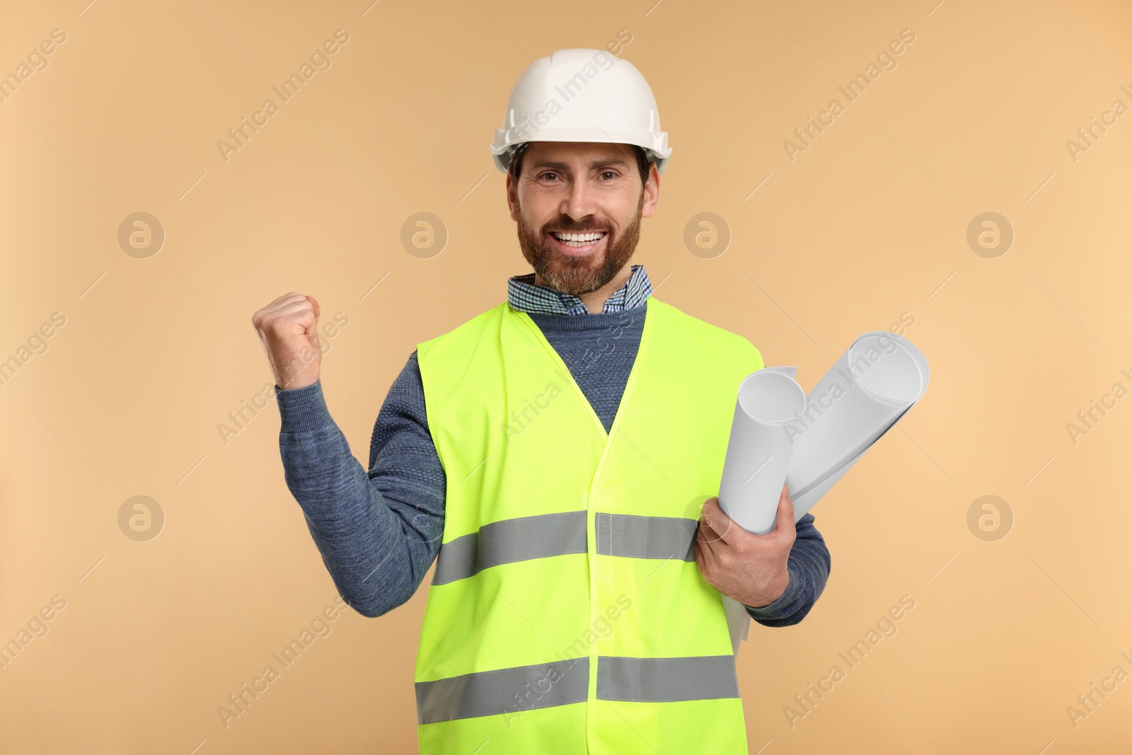 Photo of Architect in hard hat with drafts on beige background