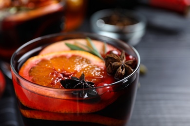 Cup of tasty mulled wine with spices, closeup