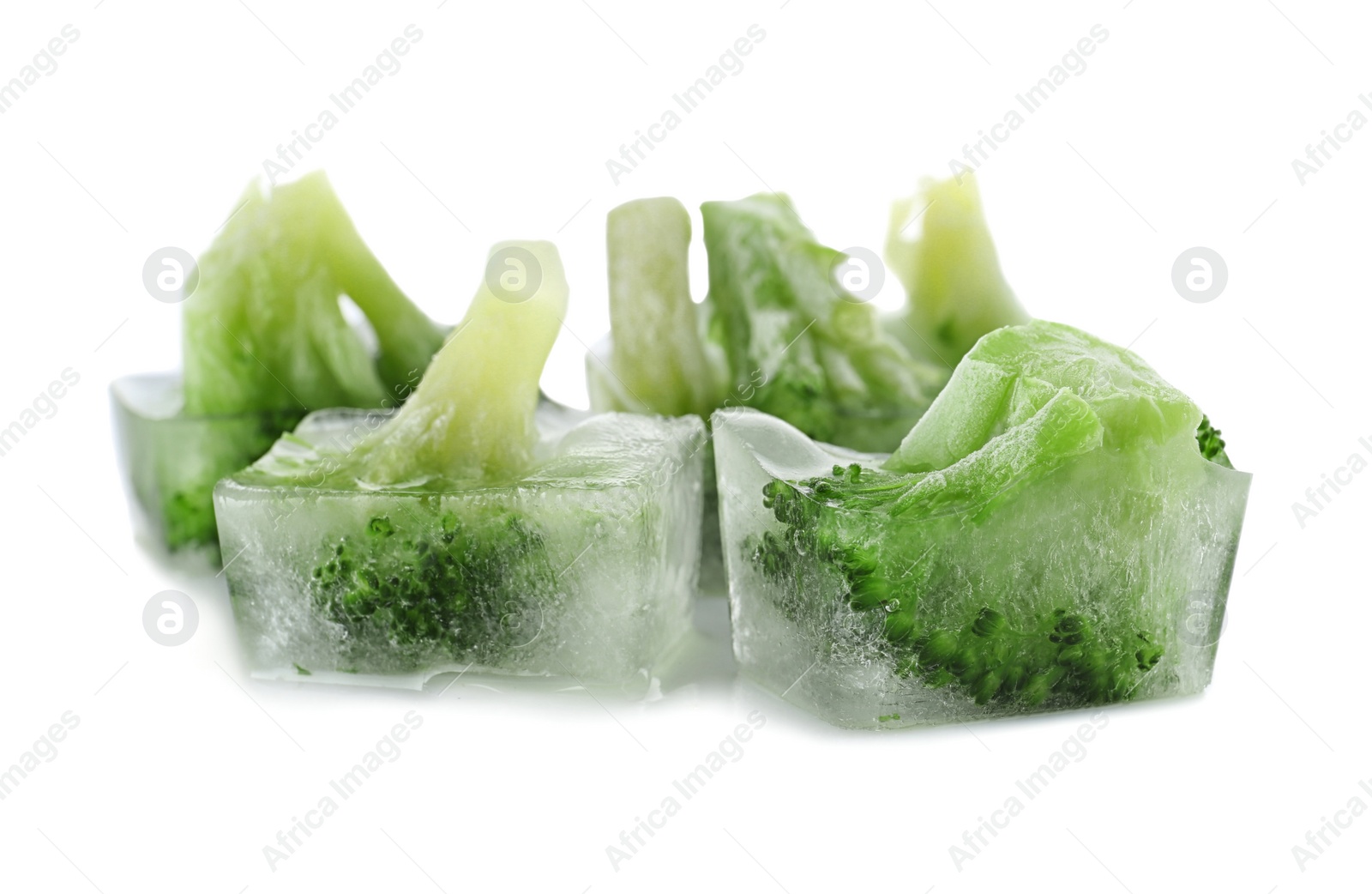 Photo of Fresh broccoli in ice cubes on white background. Frozen vegetables