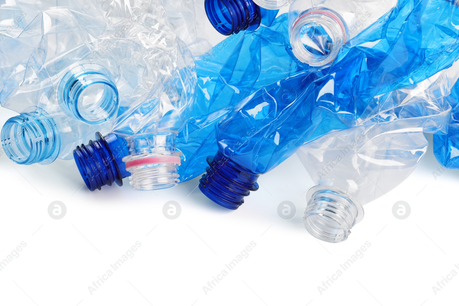 Photo of Crumpled disposable plastic bottles on white background