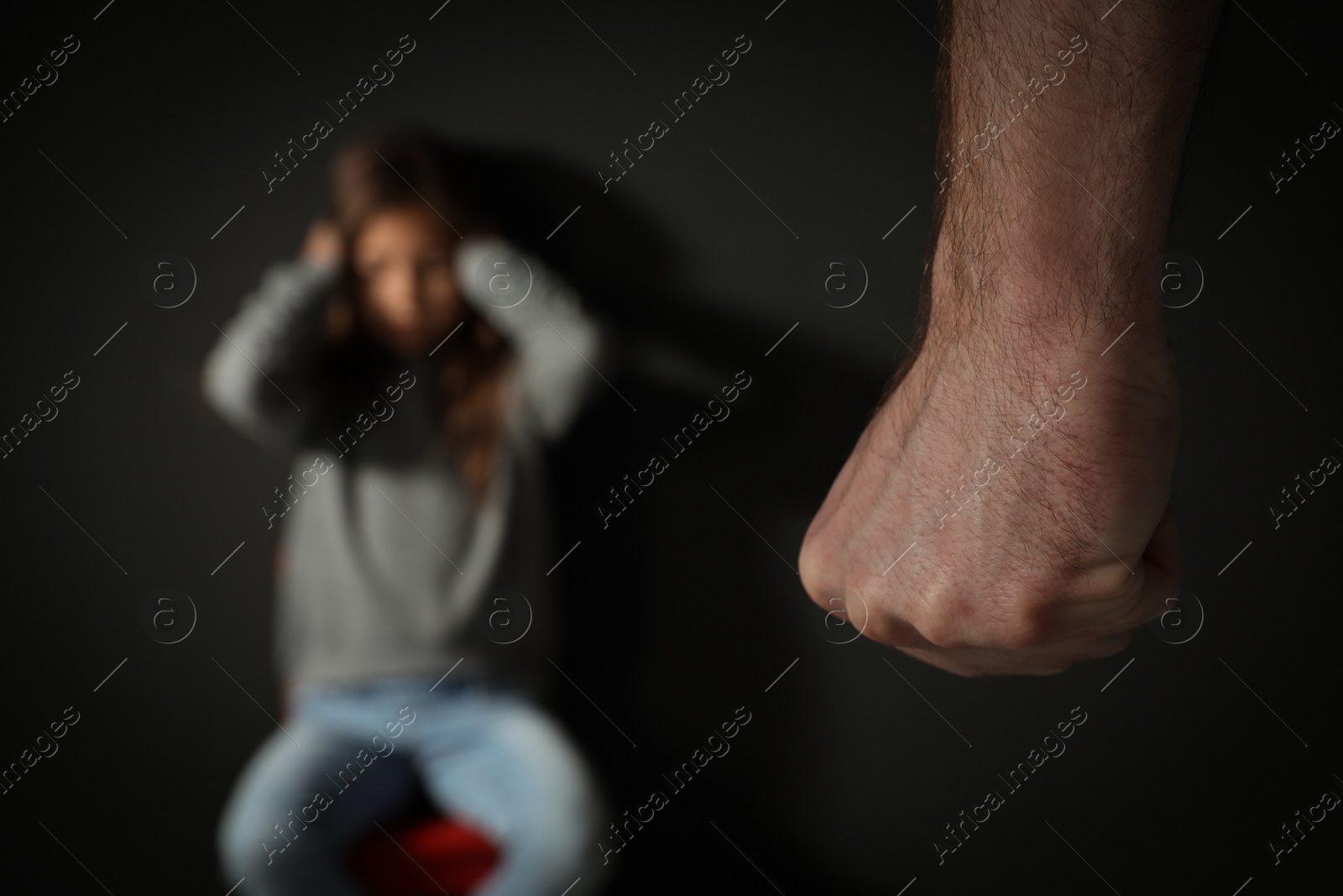 Photo of Man threatening his daughter indoors, closeup. Domestic violence concept