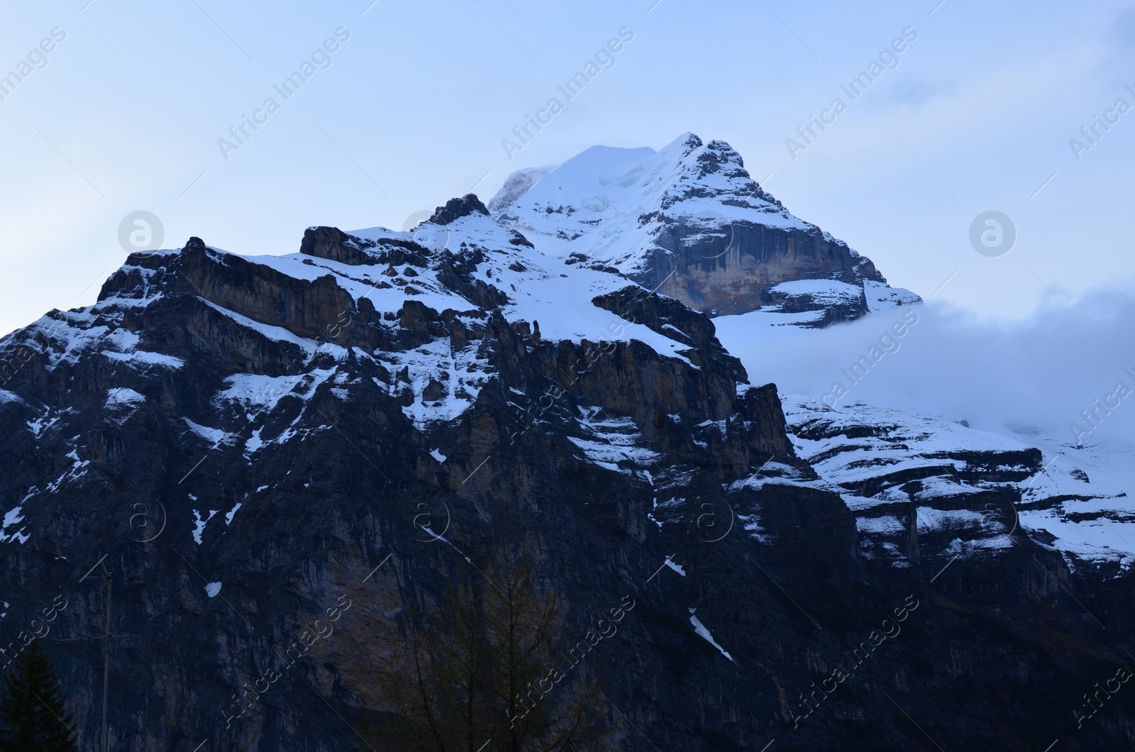 Photo of Picturesque view of high mountain peaks covered with snow