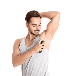 Photo of Young man using deodorant on white background