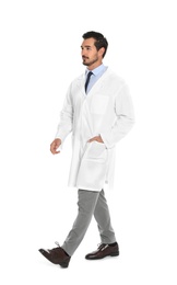 Photo of Young male doctor walking on white background. Medical service