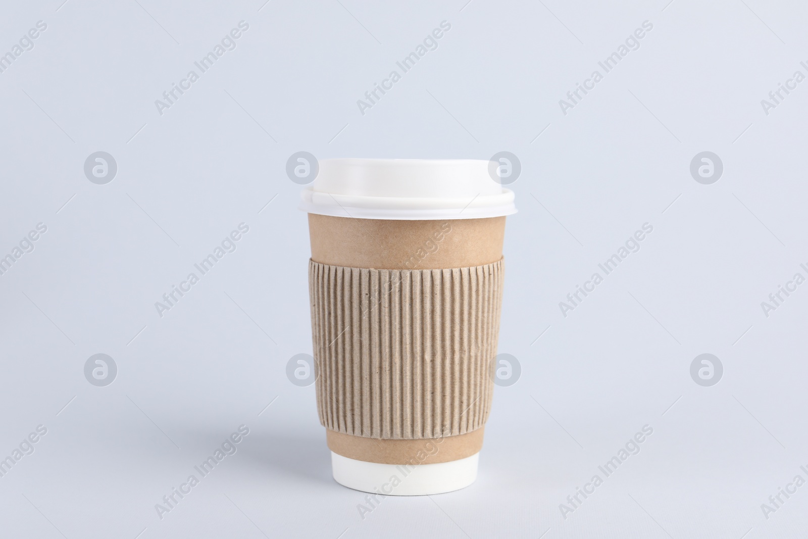 Photo of Paper cup with plastic lid on light background. Coffee to go