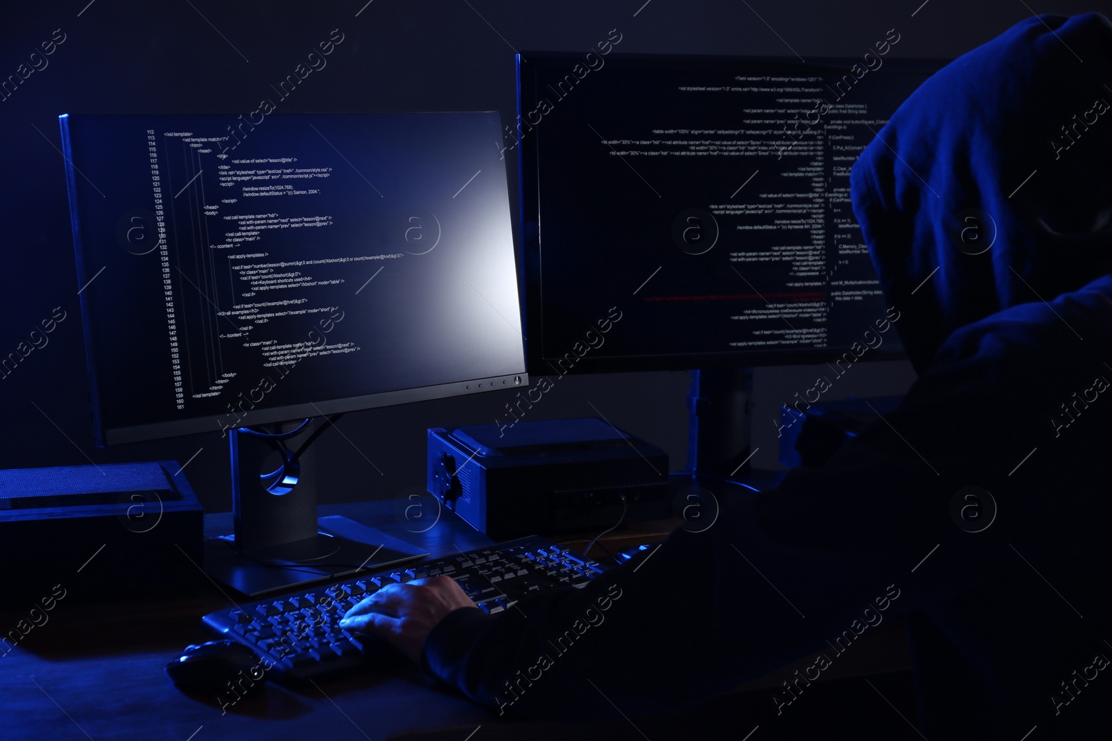 Photo of Hacker with computers in dark room. Cyber crime