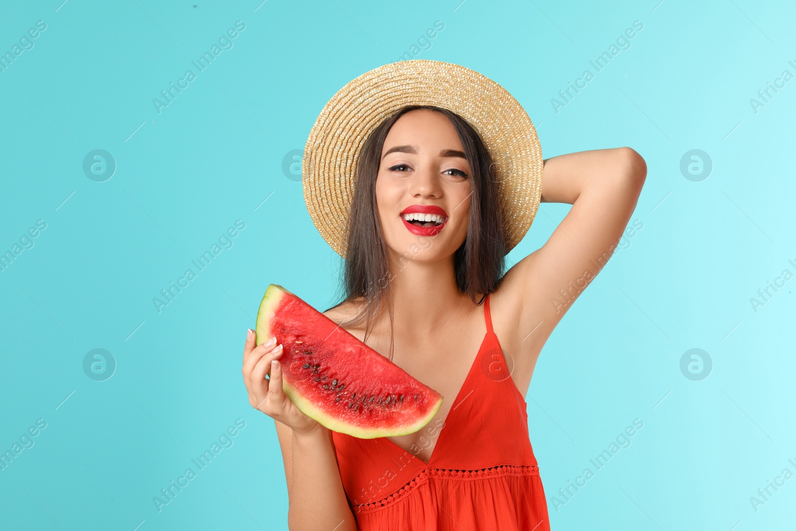 Photo of Beautiful young woman posing with watermelon on color background