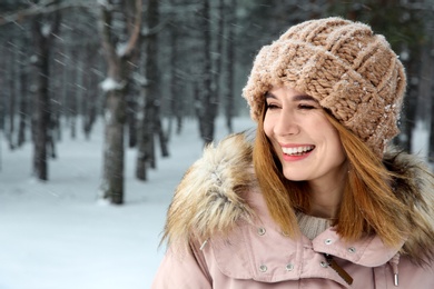 Photo of Portrait of beautiful woman in snowy forest. Space for text