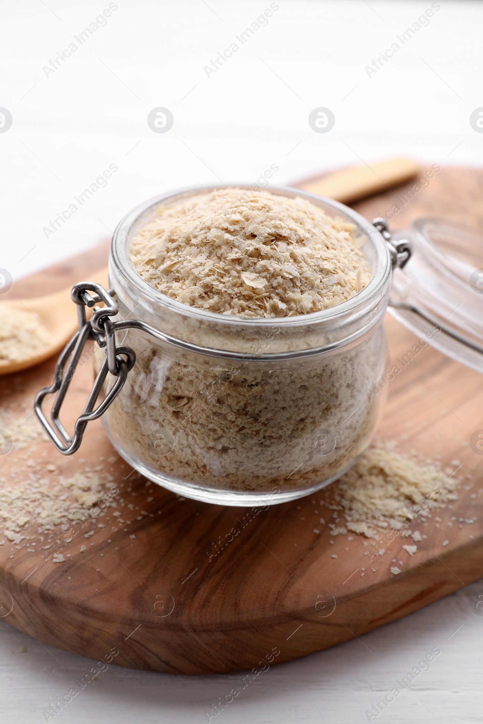 Photo of Beer yeast flakes on white wooden table, closeup