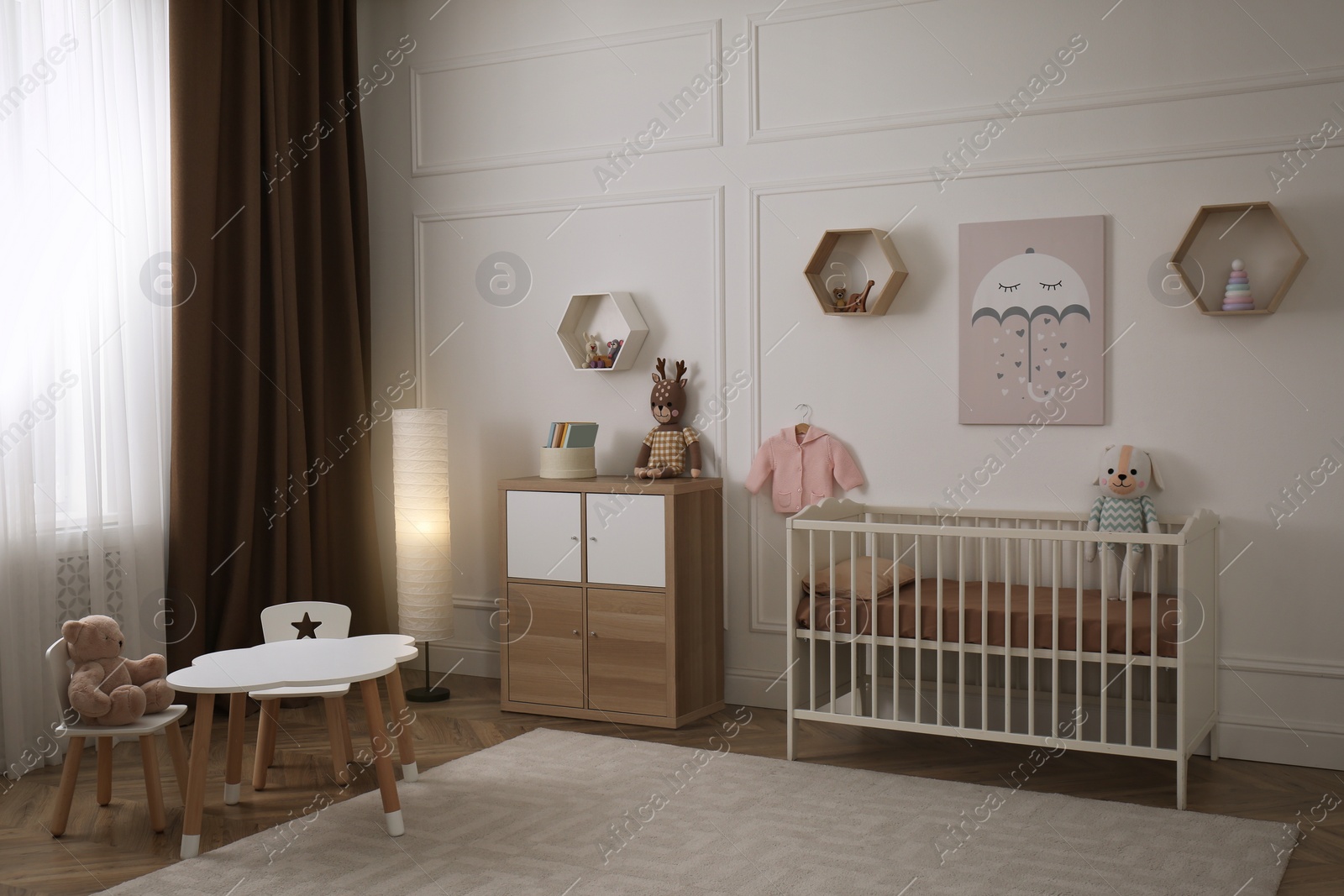 Photo of Modern baby room interior with stylish furniture and toys