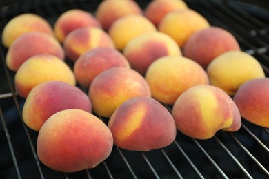 Photo of Modern grill with tasty juicy peaches, closeup