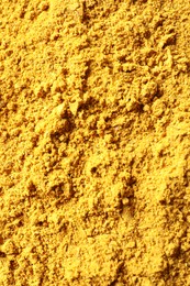 Dry curry powder as background, top view