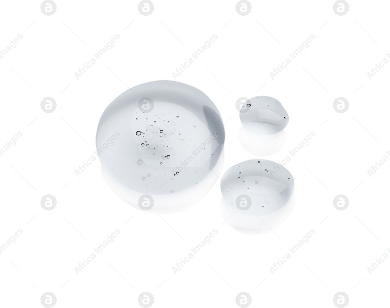 Photo of Drops of cosmetic oil on reflective surface, above view