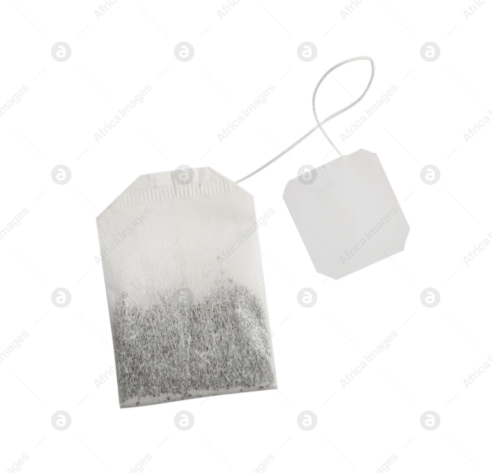 Photo of Paper tea bag with tag isolated on white, top view