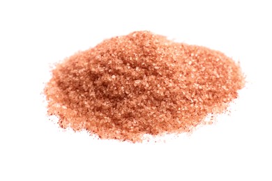 Photo of Heap of orange salt on white background