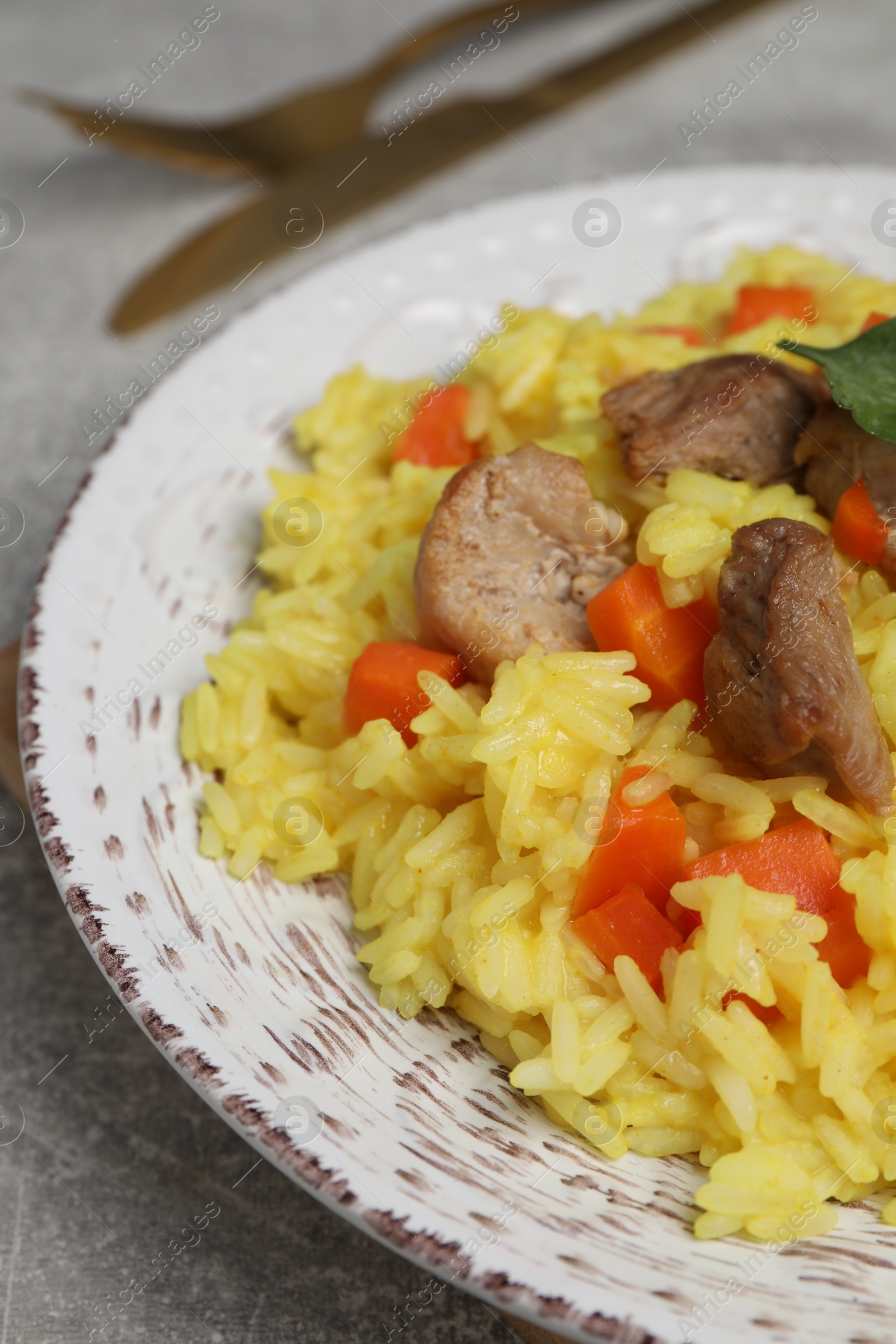 Photo of Delicious pilaf with meat on light grey table, closeup