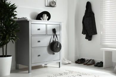 Photo of Grey chest of drawers in stylish room. Interior design