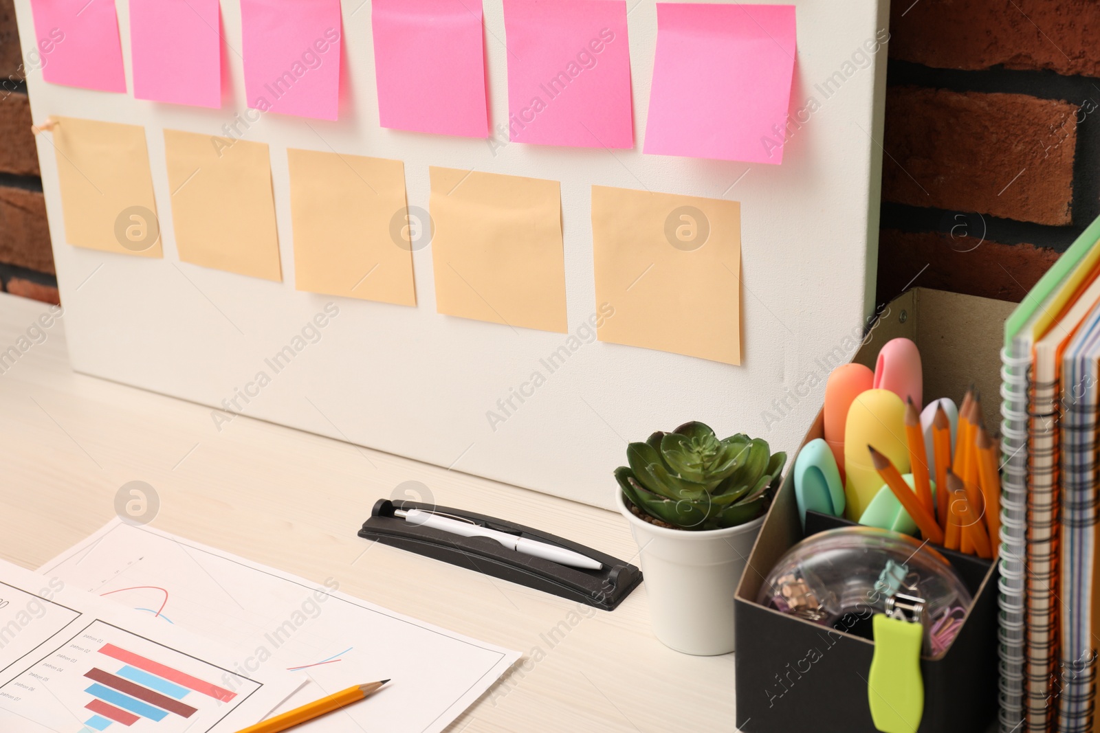 Photo of Business process planning and optimization. Workplace with colorful paper notes and other stationery on table