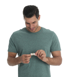Photo of Happy man with sticking plaster on white background