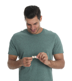 Happy man with sticking plaster on white background